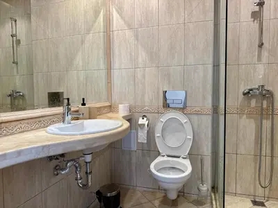 a bathroom with a toilet and a sink and a shower at Above the Sea Luxury Apartment in Varna City