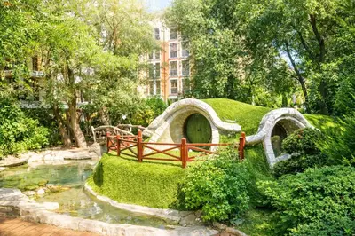 a garden with a bridge and a pond in a park at Harmony Suites 2 Private Studio 409 in Sunny Beach