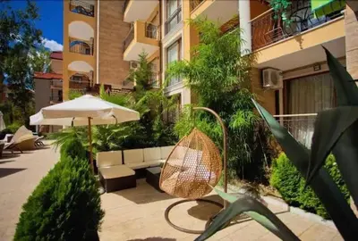 a patio with an umbrella and a chair at Harmony Suites 2 Private Studio 409 in Sunny Beach