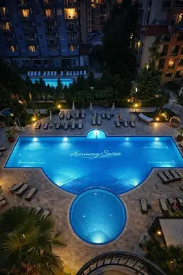 a swimming pool at night with chairs and a hotel at Harmony Suites 2 Private Studio 409 in Sunny Beach