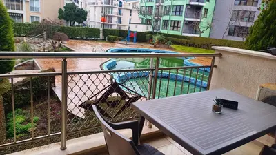 a balcony with a table and a swimming pool at Complex-Lesso in Ravda