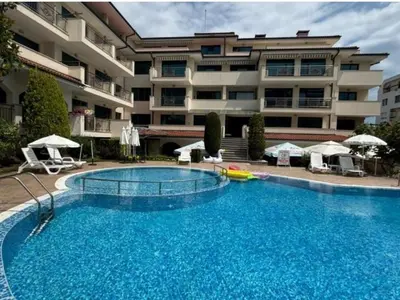 a large swimming pool in front of a building at Complex-Lesso in Ravda
