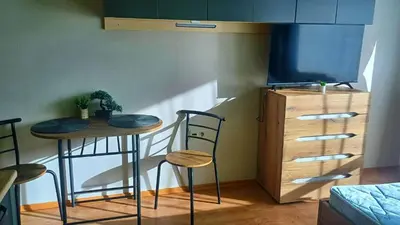 a room with two stools and a table and a tv at Complex-Lesso in Ravda