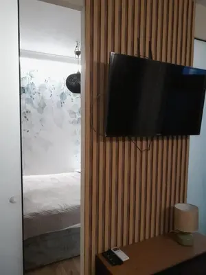 a television hanging on a wall in a bedroom at Garden of Eden- MintGarden- Sveti Vlas in Sveti Vlas