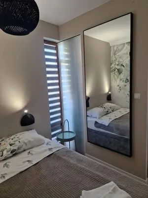 a bedroom with a mirror and a bed at Garden of Eden- MintGarden- Sveti Vlas in Sveti Vlas
