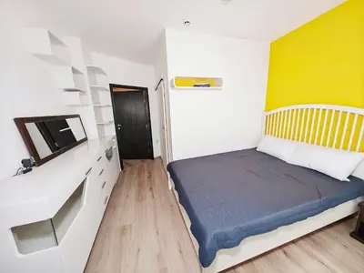 a small bedroom with a bed and a tv at KJ Apartments - SwimmingPool - 3 Min From the Beach in Burgas City
