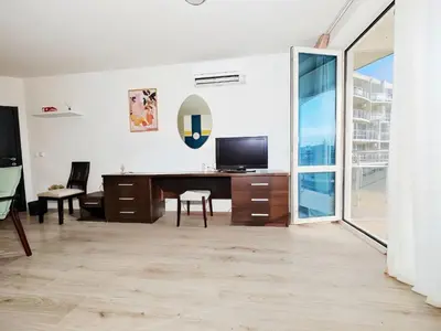 an office with a desk with a television and a window at KJ Apartments - SwimmingPool - 3 Min From the Beach in Burgas City