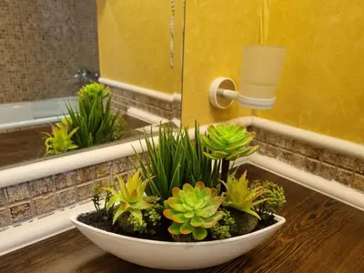 a bowl of plants on a counter in a bathroom at ROYAL BEACH HOTEL apartment SEA B in Sunny Beach