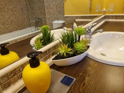 a bathroom with a sink with potted plants on a counter at ROYAL BEACH HOTEL apartment SEA B in Sunny Beach