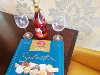 a book and two wine glasses on a table at ROYAL BEACH HOTEL apartment SEA G in Sunny Beach