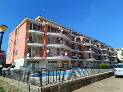 a building with a pool in front of it at Aquamarin Studio B - Słoneczny Brzeg-Nesebyr in Sunny Beach