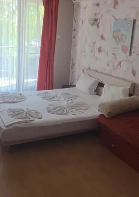 a bedroom with a bed and a window at Galqna in Sozopol