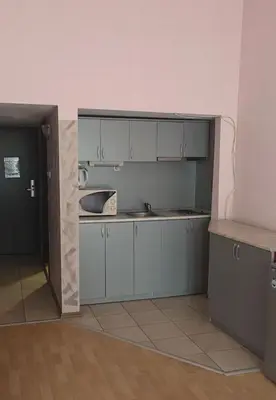 a kitchen with blue cabinets and a sink in a room at Galqna in Sozopol