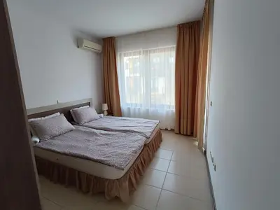 a bedroom with a bed and a large window at Апартаменти Литорал in Chernomorets