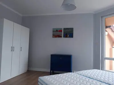 a bedroom with a bed and a blue cabinet at South Beach Apartments in Obzor