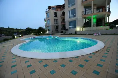 a swimming pool in front of a building at South Beach Apartments in Obzor
