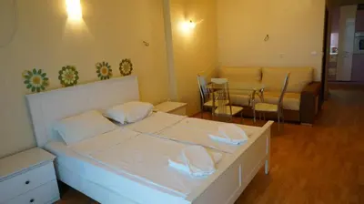 a bedroom with a bed and a living room at Privately owned Studios Bora Bora in Nesebar