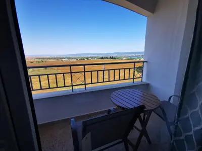 a balcony with a table and a chair and a view at Privately owned Studios Bora Bora in Nesebar