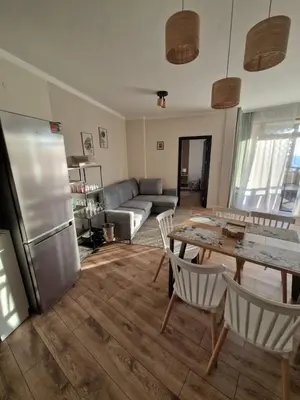 a kitchen and living room with a table and a couch at Garden of Eden- MintGarden- Sveti Vlas 1 in Sveti Vlas