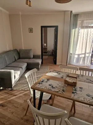 a living room with a couch and a table and chairs at Garden of Eden- MintGarden- Sveti Vlas 1 in Sveti Vlas