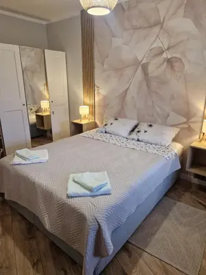 a bedroom with a large bed with towels on it at Garden of Eden- MintGarden- Sveti Vlas 1 in Sveti Vlas