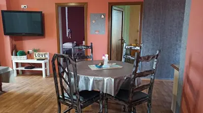 a dining room with a table with a candle on it at Панорама in Pomorie
