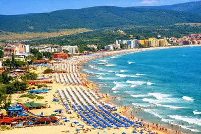 a beach with umbrellas and crowds of people at Harmony Suites-4 Private Apartment B544 in Sunny Beach