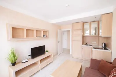 a living room with a flat screen tv and a couch at Harmony Suites-4 Private Apartment B544 in Sunny Beach