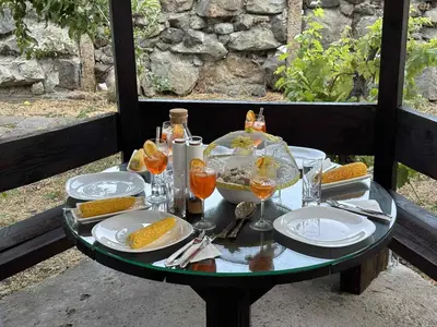 a table with plates of food and glasses of wine at Polonia - KEMNI in Burgas City
