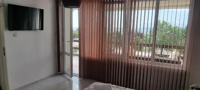 a room with a sliding glass door with a view of a balcony at Polonia - KEMNI in Burgas City