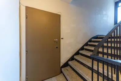 a brown door in a building with stairs at Bright City-Center Flat for 4 Guests in Varna City