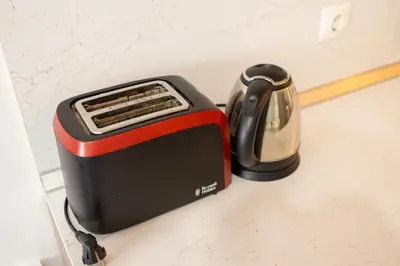 a black and red toaster sitting on a counter at Bright City-Center Flat for 4 Guests in Varna City