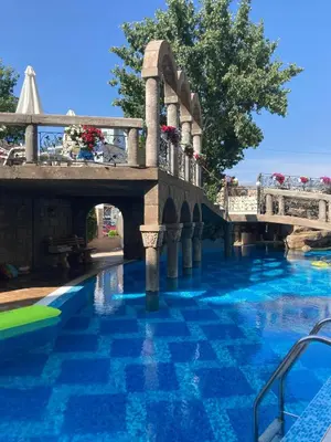 a bridge over a pool with blue water at Cozy studio in Sanny Beach in Sunny Beach
