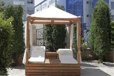 a gazebo with two chairs and an umbrella at Cozy studio in Sanny Beach in Sunny Beach