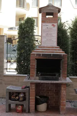 an outdoor brick pizza oven with a box at Cozy studio in Sanny Beach in Sunny Beach