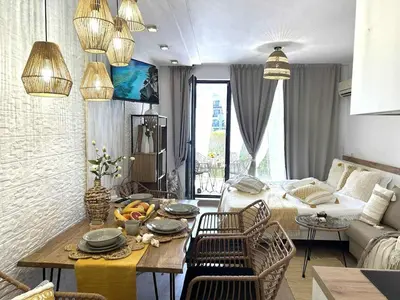 a living room with a table and a couch at Green Life Boho Apartment in Sozopol