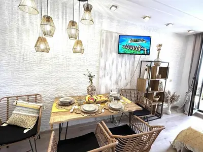 a dining room with a table and chairs at Green Life Boho Apartment in Sozopol