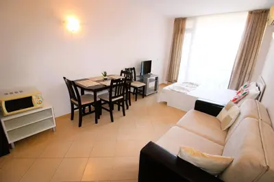 a living room with a couch and a table at Sunset Beach 3 - Menada Apartments in Sunny Beach