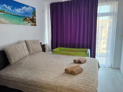 a bedroom with a bed with two towels on it at Soleil Bleu in Nesebar