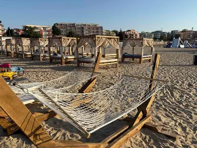 a group of chairs and hammocks on a beach at Soleil Bleu in Nesebar