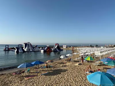 a beach with many umbrellas and people on the sand at Soleil Bleu in Nesebar