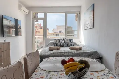 a small room with two beds and a window at Soleil Bleu Beachfront Getaway in Nesebar