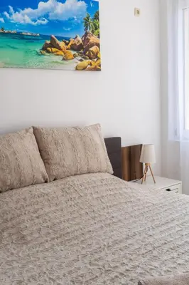 a bedroom with a bed and a painting on the wall at Soleil Bleu Beachfront Getaway in Nesebar