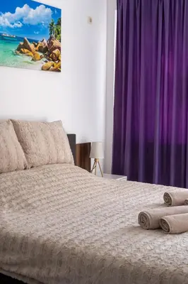 a bedroom with a bed with towels on it at Soleil Bleu Beachfront Getaway in Nesebar