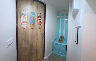 a hallway with a door with surfboards on the wall at Bit of sea in Varna City