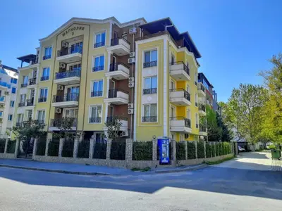 a yellow building with a fence in front of it at Magnolia 3 - Menada Apartments in Sunny Beach