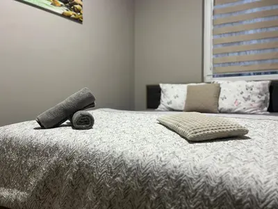 a bedroom with a bed with two pillows and a window at Varna Central Seaside Suite in Varna City
