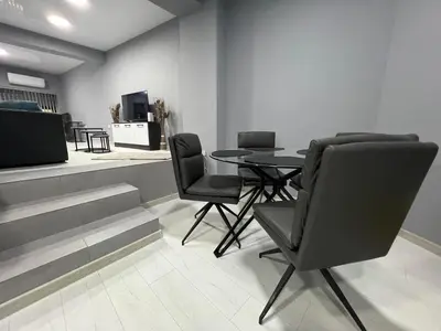 a dining room with a table and chairs at Varna Central Seaside Suite in Varna City