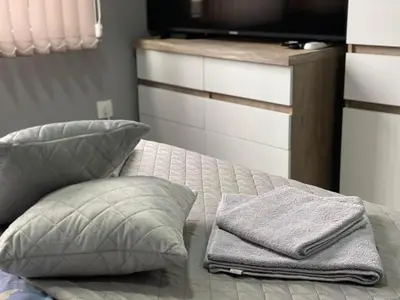 a bed with a pillow and towels on it at NJ Collection in Varna City