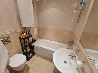 a bathroom with a sink and a tub and a toilet at Large Two Floor Apartment in Byala